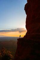 silhueta do uma mulher em a trilha às catedral Rocha às pôr do sol dentro sedona. a colorida pôr do sol sobre Sedona catedral Rocha marco. foto