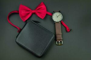Preto homens carteira, vermelho arco gravata e couro relógio de pulso. conjunto do masculino acessórios foto