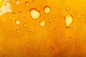 textura dourada de cera de cannabis, fundo de maconha foto