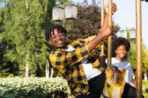 duas mulheres afro-americanas felizes em um parque em um passeio de diversão foto
