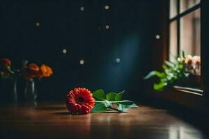 uma solteiro vermelho flor senta em uma mesa dentro frente do uma janela. gerado por IA foto