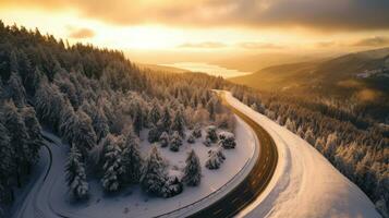 aéreo Visão do ventoso e cheio de curvas estrada dentro neve coberto floresta panorama. generativo ai foto