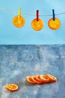 fatias de laranjas ou tangerinas secas são penduradas no varal foto