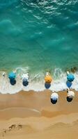 deslumbrante de praia cena a partir de acima, com guarda-chuvas, turquesa mar, e espreguiçadeiras vertical Móvel papel de parede ai gerado foto
