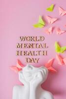 mundo mental saúde dia texto e gesso cabeça e borboletas em Rosa fundo. foto