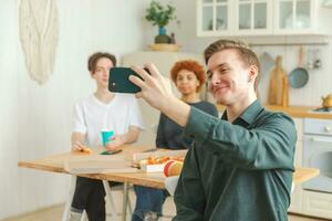 Felicidades funky humor. feliz grupo do amigos faço selfie. homem levando foto do amigos às Festa. grupo do multirracial jovem pessoas levando foto em telefone. jovem pessoas apreciar seus companhia sorrir ter Diversão.