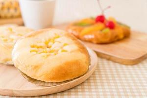 pão com milho e maionese na mesa foto