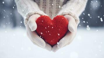 fêmea mãos dentro luvas segurando vermelho coração em Nevado inverno fundo. generativo ai foto