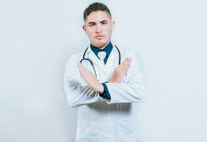 médico cruzando mãos dentro negação gesto isolado. jovem médico fazer Pare placa com mãos isolado foto