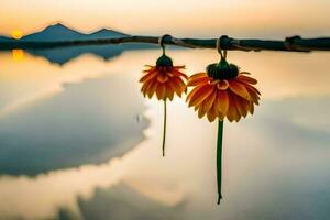 dois flores suspensão a partir de uma ramo sobre uma lago. gerado por IA foto