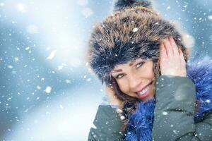 lindo sorridente jovem mulher dentro caloroso roupas. a conceito do retrato dentro inverno Nevado clima foto