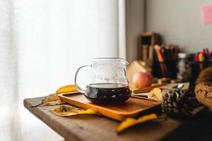 café em uma caneca na mesa no outono foto