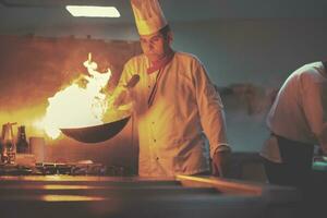 chef fazendo flambe na comida foto