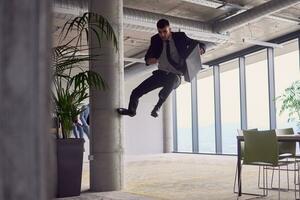 dentro a moderno escritório, uma homem de negocios com uma pasta cativa todos Como ele executa emocionante aéreo acrobacia, desafiador gravidade com dele ousadia saltos e exibindo dele agilidade com tirar o fôlego espetáculo. foto