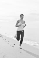 mulher correndo na praia foto