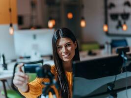 uma jovem mulher usando uma Câmera para presente dela o negócio com conectados clientes foto