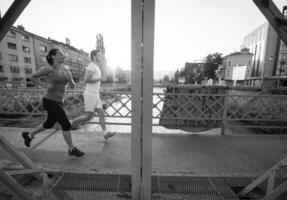 jovem casal correndo pela ponte na cidade foto