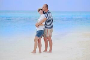 feliz casal jovem se divertir na praia foto