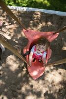 menina balançando em um playground foto