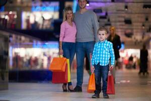 jovem família com sacolas de compras foto