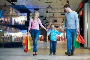 jovem família com sacolas de compras foto