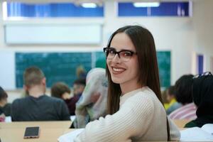 menina sentada em um anfiteatro e conversando com seus colegas foto