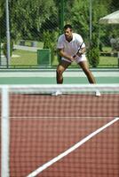 jovem homem jogar tênis ao ar livrejovem homem jogar tênis ao ar livre foto