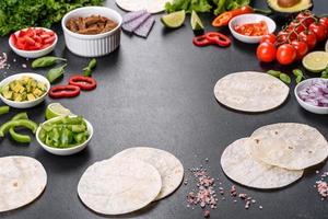tacos mexicanos com carne, tomate, abacate, cebola e molho de salsa foto