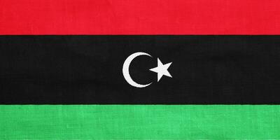 bandeira do Estado do Líbia em uma texturizado fundo. conceito colagem. foto