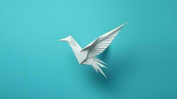 papel origami pássaro isolado em azul fundo foto