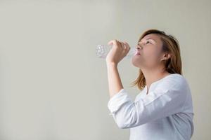 jovem mulher bebendo água parece tão fresca foto