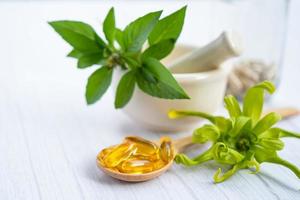 cápsula de ervas orgânicas de medicina alternativa com vitamina e foto