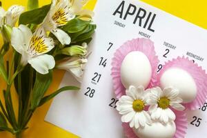 abril 2020 Páscoa por mês calendário com colorida ovos e Primavera flores foto