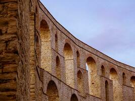 curvado antigo romano aqueduto dentro Centro do cavala cidade - Grécia foto