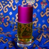 Frasco de perfume com uma cor de perfume amarela em um fundo de batique azul