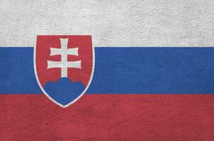 bandeira da eslováquia retratada em cores de tinta brilhantes na parede de reboco em relevo antigo. banner texturizado em fundo áspero foto