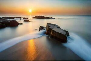 uma grandes exposição fotografia do pedras em a de praia às pôr do sol. gerado por IA foto