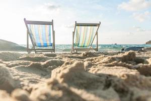 espreguiçadeiras de férias de verão em praia tropical foto