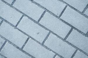 Padrão de pavimento de tijolos de blocos de forma retangular feita de pedra cinza foto