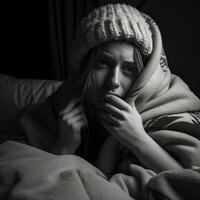 uma mulher é embrulhado acima dentro uma cobertor e sentado em uma cama generativo ai foto