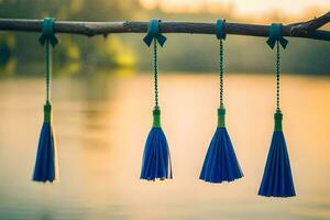 azul borlas suspensão a partir de uma ramo de uma lago. gerado por IA foto