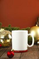 Natal zombar acima do branco caneca em de madeira mesa com festivo decorações. dourado Natal bolas contra vermelho muro. foto