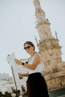 fêmea turista com cidade mapa de a santo Oronzo estátua dentro ostuni, Itália foto