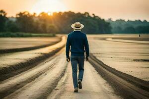 uma homem dentro uma chapéu anda em baixa uma sujeira estrada às pôr do sol. gerado por IA foto