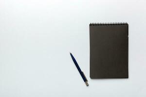 escola caderno em uma colori fundo, espiral Preto bloco de anotações em uma mesa topo Visão foto