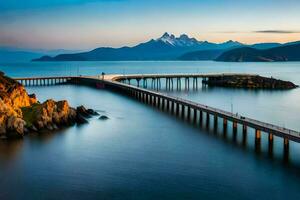 a ponte abrangendo a oceano e montanhas às pôr do sol. gerado por IA foto