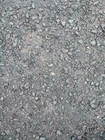 asfalto rude e rochoso grunge superfície, textura fundo, cinzento pavimentou estrada foto