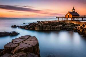 uma pequeno de madeira casa senta em a pedras às pôr do sol. gerado por IA foto