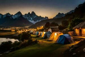 tendas estão aceso acima às noite dentro frente do uma montanha faixa. gerado por IA foto