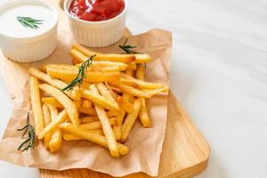 batatas fritas com creme de leite e ketchup foto